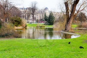 urban pond in Paris with green grass around in spring