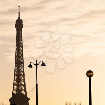 urban lantern and eiffel tower in Paris on yellow sunset
