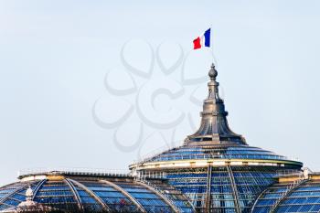 french state flag on Great Palace dome in Paris in evening