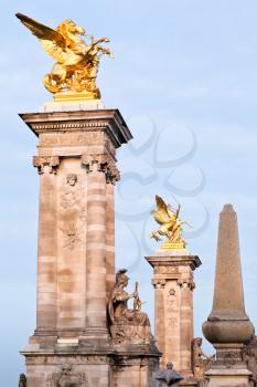 columns and statues of Pont Alexandre iii in Paris