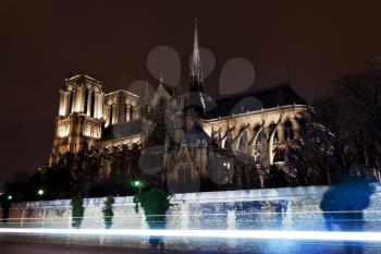cathedral Notre-Dame de Paris and Seine River traffic at night