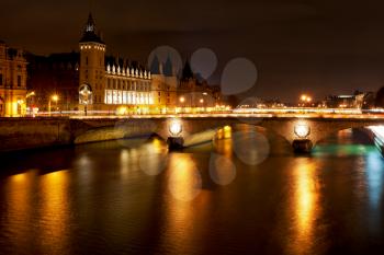 Panorama of Seine with pont au change in Paris at night