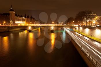Panorama of Seine with quay and pont au change in Paris at night