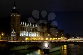 Conciergerie Palace and Pont au Change in Paris at night