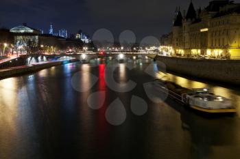 Panorama of Seine with ships in Paris at night