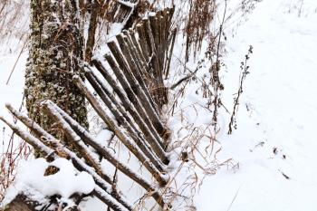 rickety wooden palisade in winter village