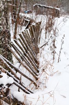 backyard rickety fence in winter village