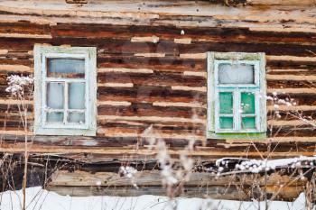 old timbered wall of rustic house in winter