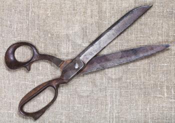 old tailor shears on textile background