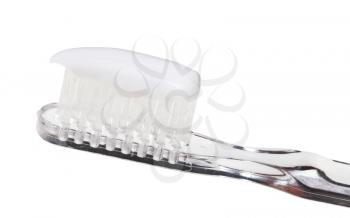 extruded toothpaste on toothbrush close up isolated on white background