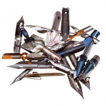 heap of used metal drawing pens isolated on white background
