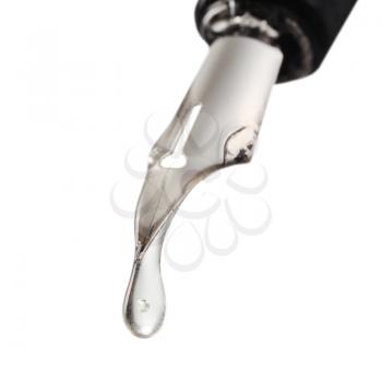 transparent drop dripping from the nib of pen close up