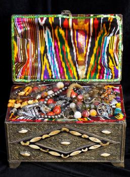 ancient east treasure chest with antique jewelry on black velvet