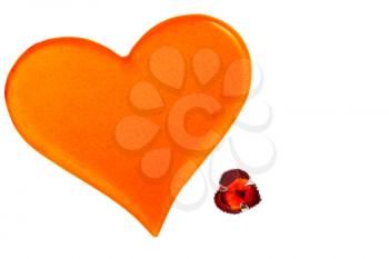 large orange plastic heart and small red glass heart isolated on white background