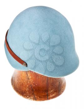 felt light blue soft cap on wooden block isolated on white background