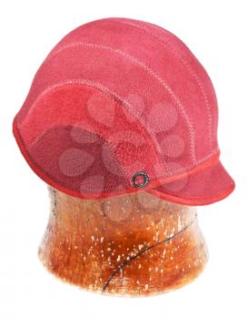 felt red cap on wooden block isolated on white background