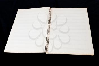 two-page spread of old music book with black background