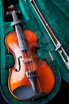 violin with bow in green velvet box close up