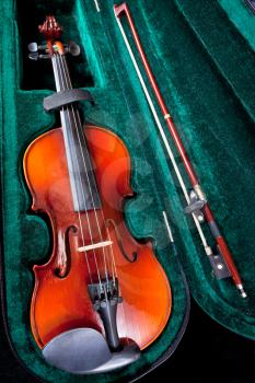violin with bow in green velvet case close up