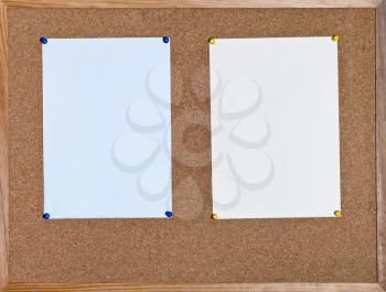 blue and yellow sheets of paper on cork board in wooden frame