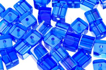 blue glass cubic bugles close up isolated on white background