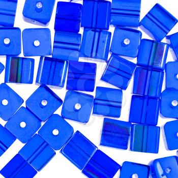blue glass cubic beads close up isolated on white background