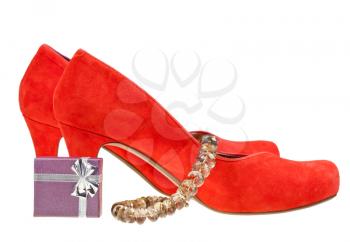 pairs of red high heel pumps with small gift box and necklace isolated on white background