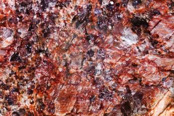 background from pink mineral with crystalline inclusions close up
