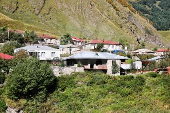 houses of village Stepantsminda at foot of Mount Kazbek in Caucasus Mountains in Georgia