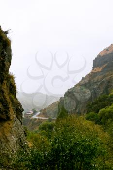 Cliffs and the road in gorge of Azat river in Armenia in rain Cliffs surrounding Geghard monastery and Azat river gorge are included together with the monastery in the World Heritage Site listing.
