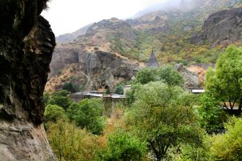 View of Geghard monastery from cliff in Armenia. Cliffs surrounding Geghard monastery and Azat river gorge are included together with the monastery in the World Heritage Site listing.