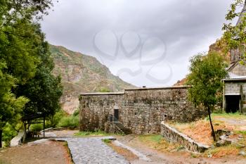 path around the ancient stone walls of medieval geghard monastery in Armenia