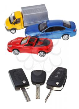 above view three vehicle keys and model cars isolated on white background