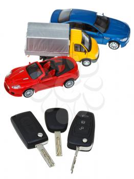top view of three vehicle keys and model cars isolated on white background