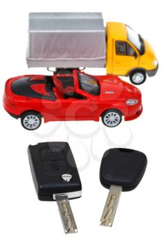 two vehicle keys and model truck and car isolated on white background