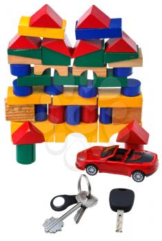 above view of door keys, vehicle key, new red car model and wooden block toy house isolated on white background