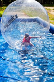 child in water ball in open swimming pool