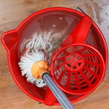 top view of washing mop in red bucket