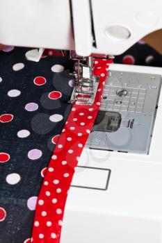 sewing clothing on sewing machine close up