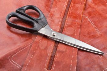 tailor shears on details of brown leather pattern