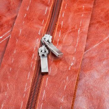 metal runners of zipper on cutting hide clothing