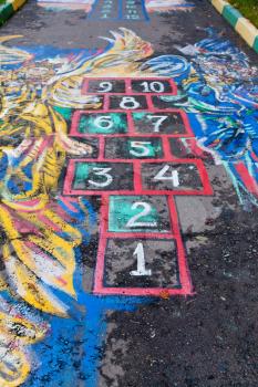 Hopscotch court drawn by chalk on urban pavement