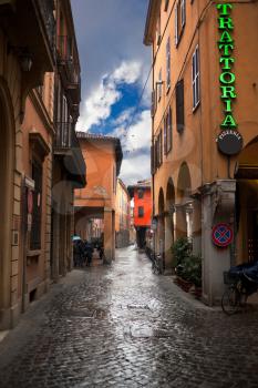typical medieval street in historical district of Bologna, Italy in autumn