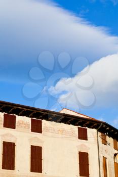 big white clouds in blue sky under medieval house in Padua, Italy