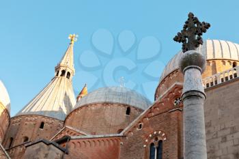 column with stone cross and domes of Padua Cathedral, in Padua, Italy