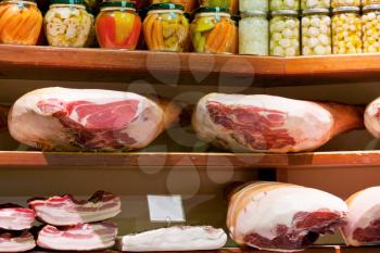 hams and salty bacon in small local shop in Bologna, Italy
