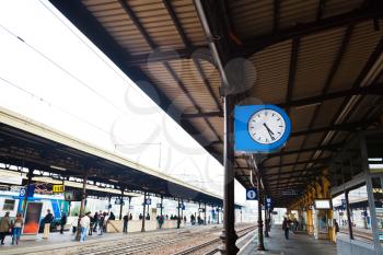 outdoor clock on railway platform at autumn day