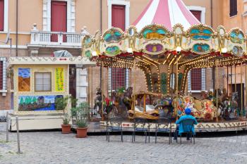 Traditional merry-go-round carousel on town square in Ravenna, Italy