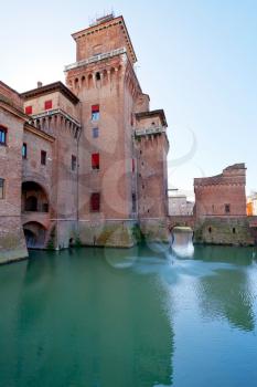 side view moat and Castello Estense in Ferrara, Italy