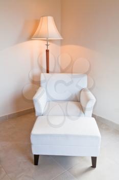 white leather chair and stand lamp in room corner